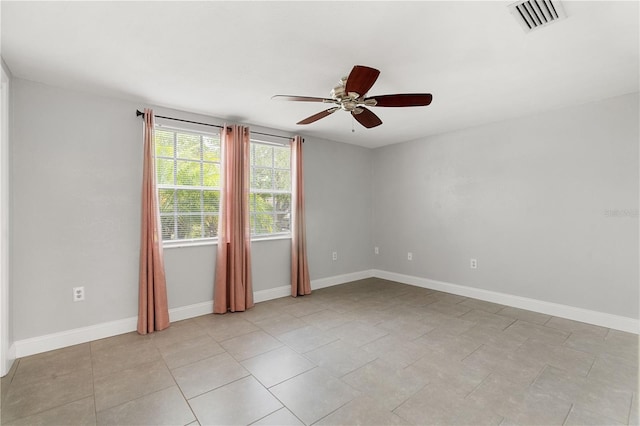 empty room with ceiling fan and baseboards