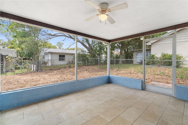 unfurnished sunroom with a ceiling fan