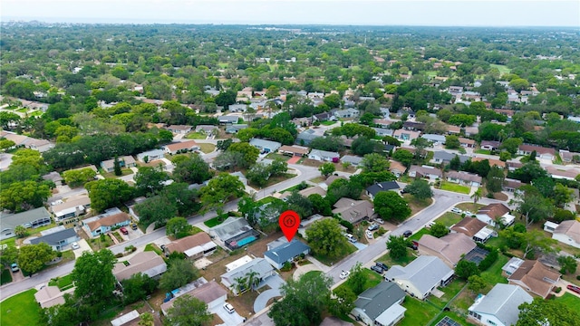 aerial view of property and surrounding area featuring nearby suburban area