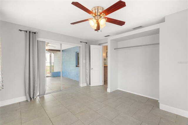 12407 Gunstock Ln, Hudson, FL 34667 - unfurnished bedroom featuring baseboards, light tile patterned flooring, ceiling fan, and access to outside
