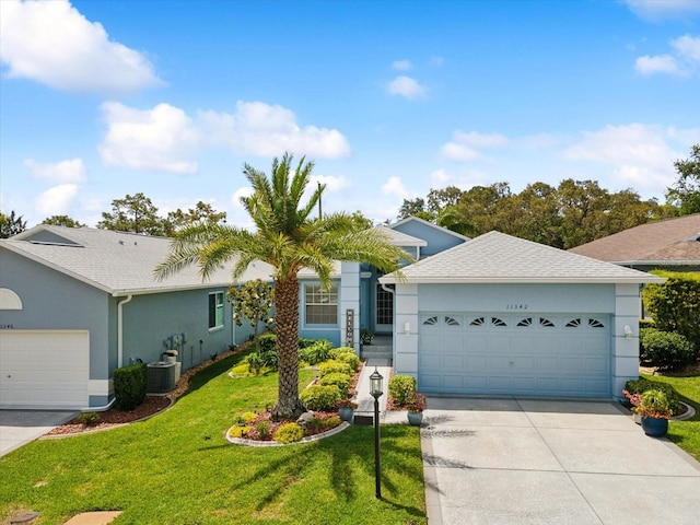 ranch-style home with stucco siding, driveway, an attached garage, and a front yard