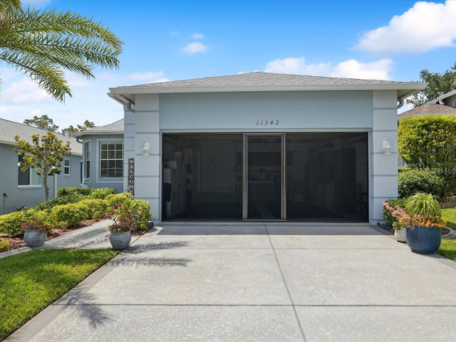 view of building exterior with driveway and a garage