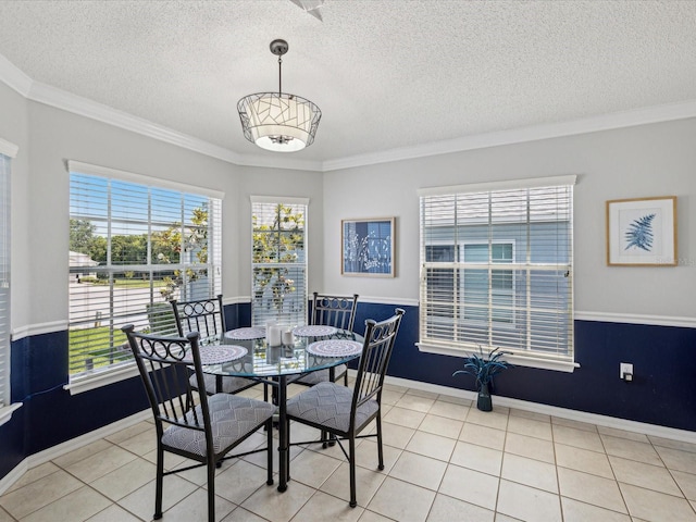 dining space with a textured ceiling, light tile patterned floors, crown molding, and baseboards