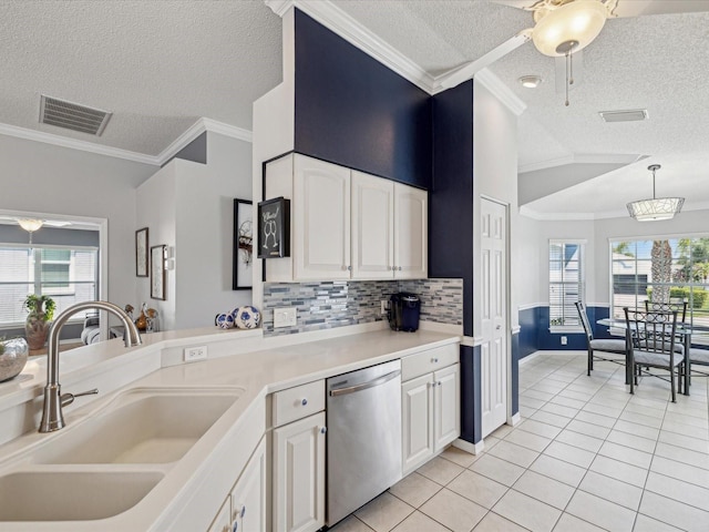 kitchen with stainless steel dishwasher, a sink, a textured ceiling, light tile patterned floors, and a ceiling fan