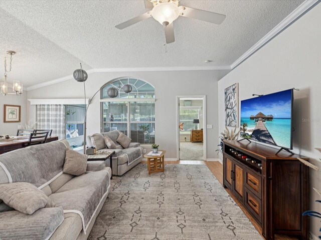 11342 Hollander Ave, Hudson, FL 34667 - living room featuring a textured ceiling, ornamental molding, wood finished floors, ceiling fan, and a chandelier