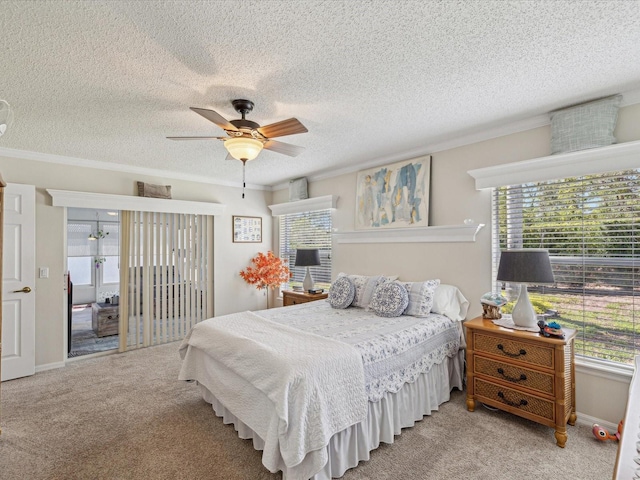 carpeted bedroom featuring crown molding, a textured ceiling, and ceiling fan