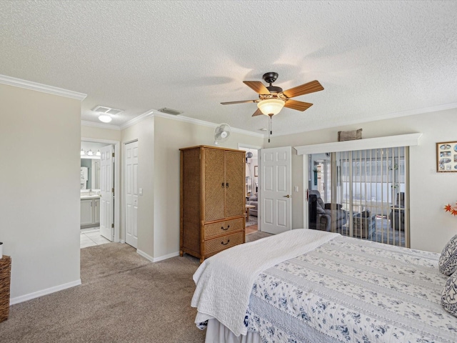 carpeted bedroom featuring baseboards, a textured ceiling, ornamental molding, connected bathroom, and a ceiling fan