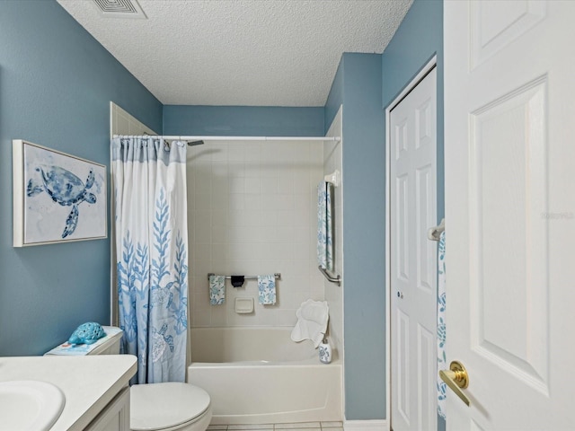 full bath with vanity, a textured ceiling, shower / bath combo, toilet, and tile patterned floors