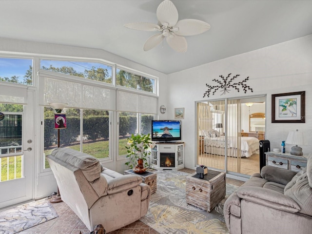 living area featuring vaulted ceiling and a ceiling fan