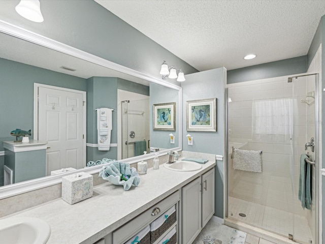 11342 Hollander Ave, Hudson, FL 34667 - bathroom featuring double vanity, a shower stall, a textured ceiling, and recessed lighting