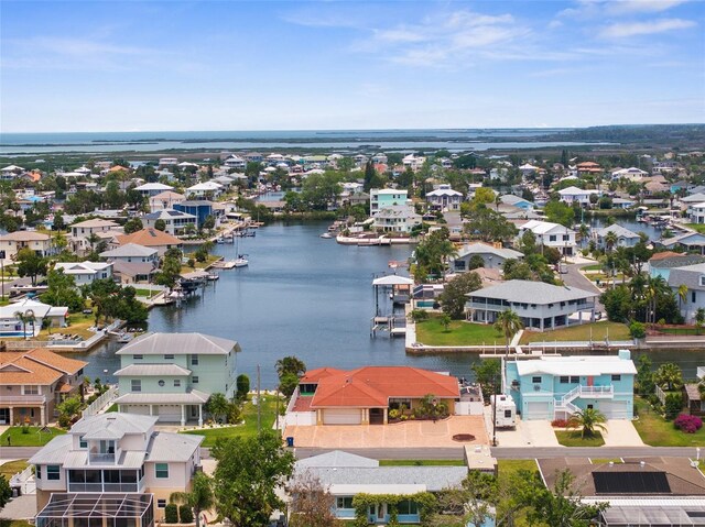aerial view of residential area featuring a large body of water