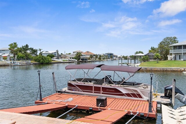 dock area with a water view, a residential view, and boat lift