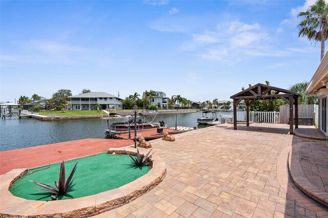 dock area featuring a gazebo, a water view, and fence