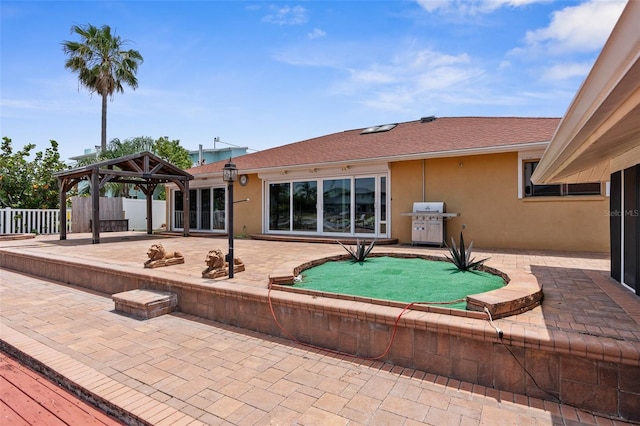 view of pool featuring a gazebo, a patio area, fence, and a grill