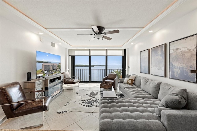 4550 Bay Blvd Unit 1231, Port Richey, FL 34668 - living area featuring a tray ceiling, light tile patterned floors, a ceiling fan, expansive windows, and a textured ceiling