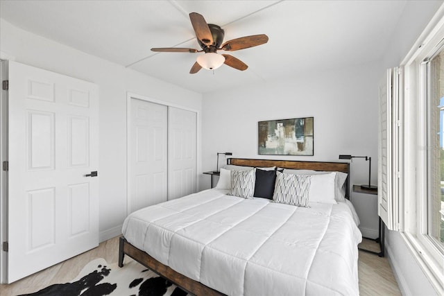 4550 Bay Blvd Unit 1231, Port Richey, FL 34668 - bedroom featuring multiple windows, light wood-type flooring, a closet, and ceiling fan