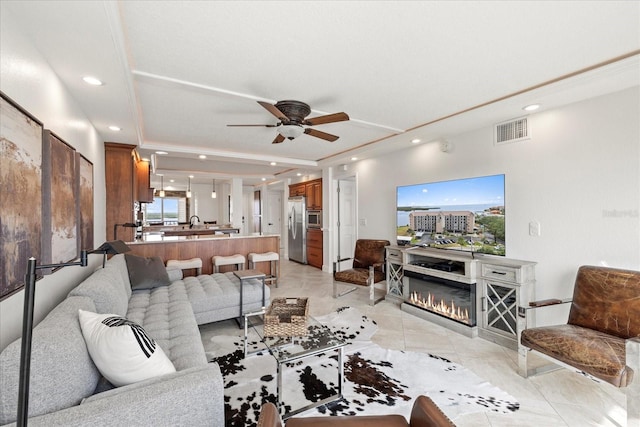 4550 Bay Blvd Unit 1231, Port Richey, FL 34668 - living room with a ceiling fan, recessed lighting, a glass covered fireplace, and a raised ceiling