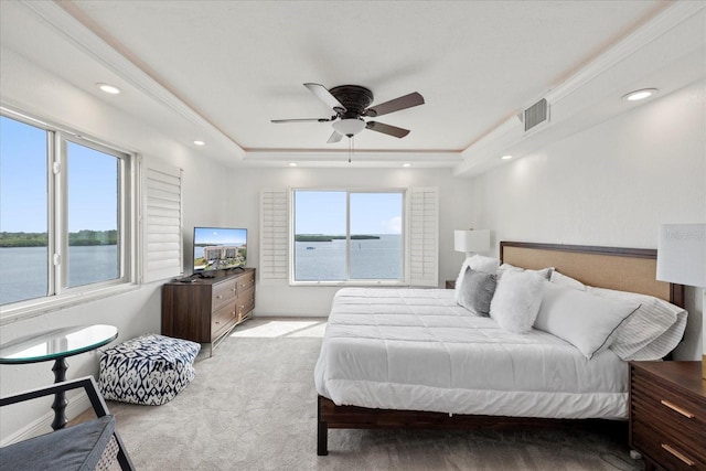 4550 Bay Blvd Unit 1231, Port Richey, FL 34668 - bedroom with a water view, light carpet, a tray ceiling, recessed lighting, and ceiling fan