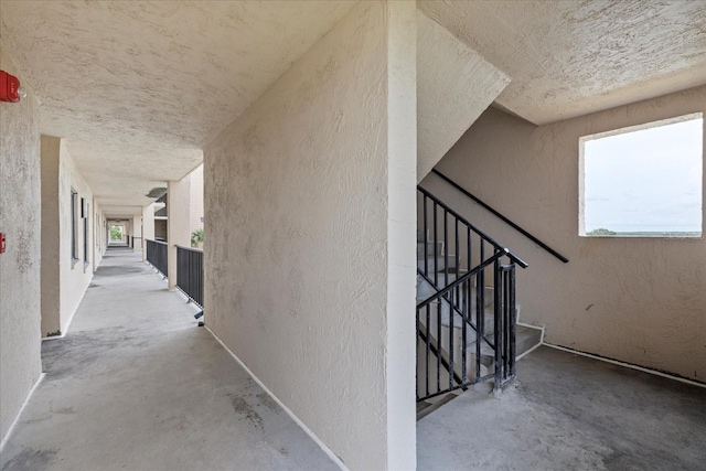 4550 Bay Blvd Unit 1231, Port Richey, FL 34668 - hallway featuring unfinished concrete floors and a textured wall