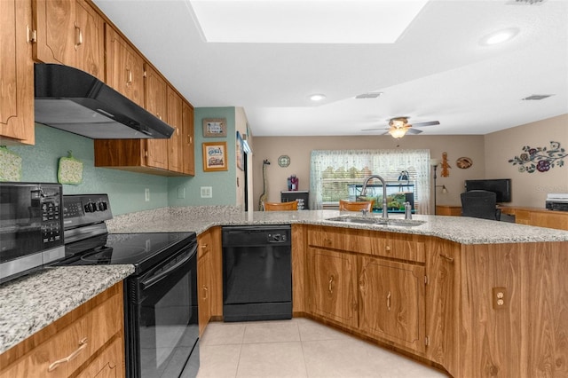kitchen featuring a peninsula, a sink, brown cabinetry, black appliances, and under cabinet range hood
