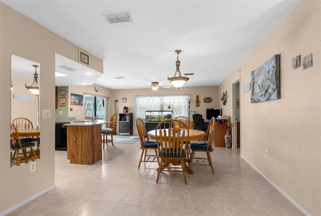 dining area featuring baseboards, ceiling fan, and visible vents