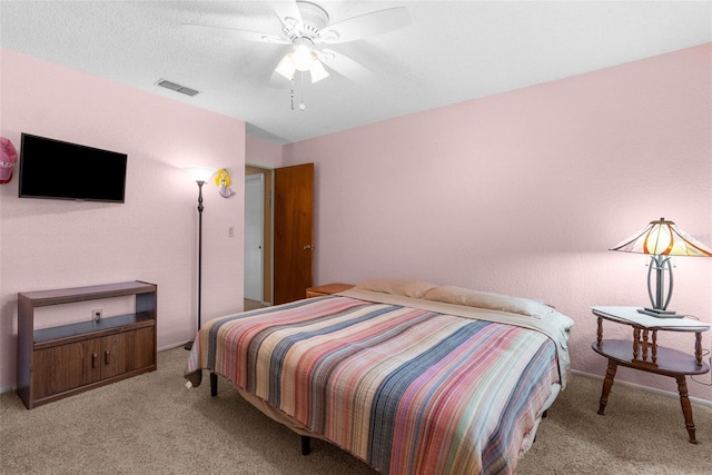 bedroom featuring light carpet, visible vents, and ceiling fan