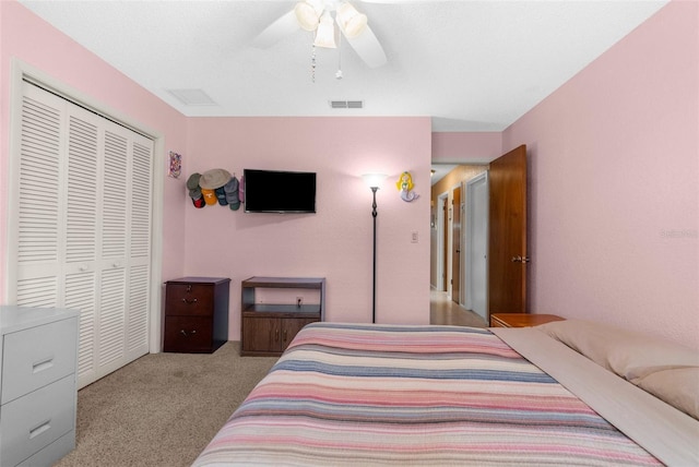 carpeted bedroom featuring a ceiling fan, a closet, and visible vents