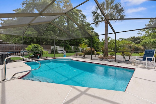 view of swimming pool featuring a patio area, a fenced in pool, a fenced backyard, and a lanai