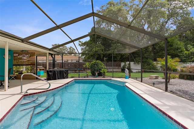 view of swimming pool with a patio, a fenced in pool, a fenced backyard, and glass enclosure