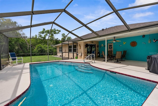 pool with a lanai, a patio, and a ceiling fan
