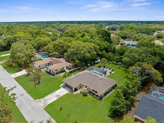 birds eye view of property with a view of trees