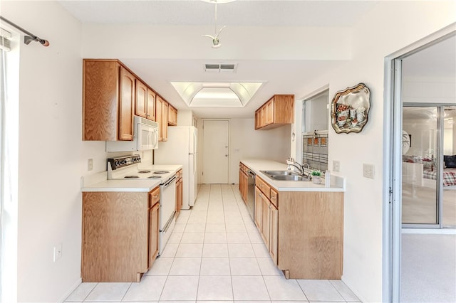 kitchen featuring a sink, visible vents, white appliances, light countertops, and light tile patterned flooring