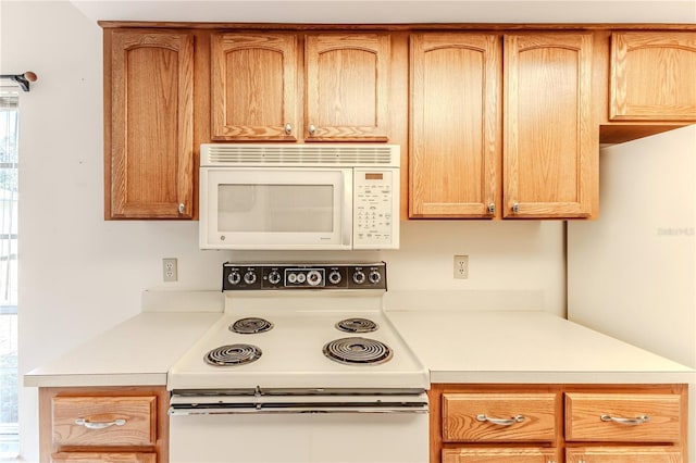 kitchen with light countertops and white appliances