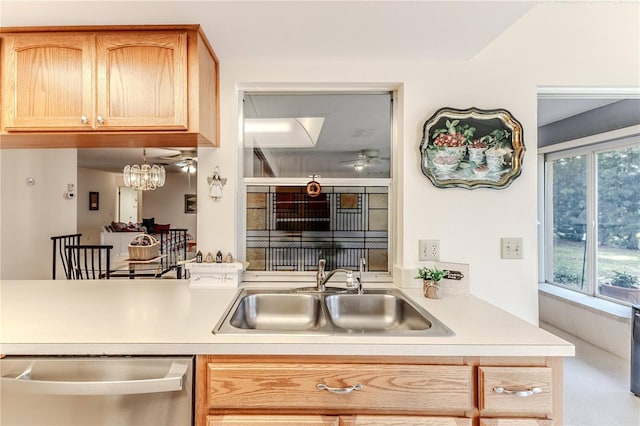 kitchen featuring light countertops, light brown cabinetry, a sink, and dishwasher