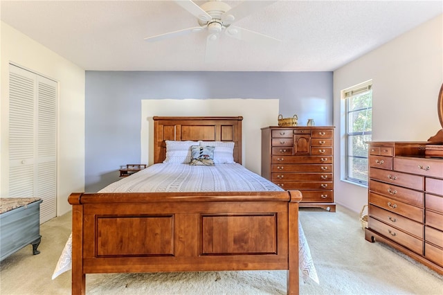 bedroom with light carpet, a closet, and ceiling fan