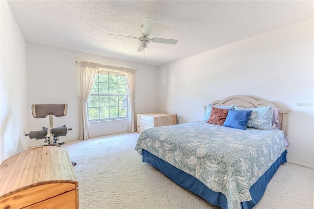 carpeted bedroom with a textured ceiling and ceiling fan