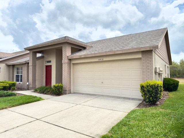 view of front facade with brick siding, concrete driveway, a garage, and a shingled roof