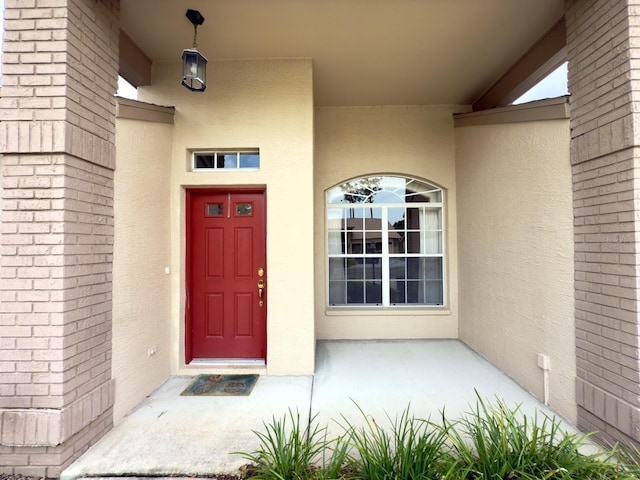 property entrance featuring stucco siding