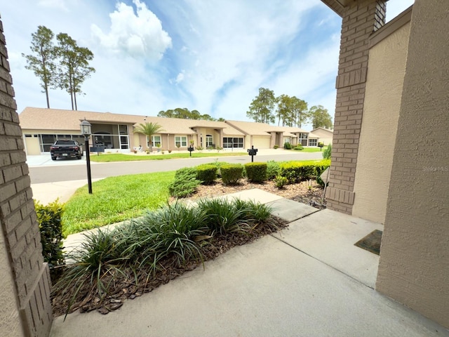 view of yard with a garage and driveway
