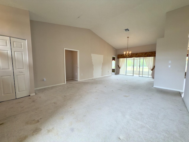 unfurnished living room featuring a chandelier, light carpet, vaulted ceiling, and baseboards
