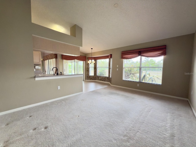 unfurnished living room featuring vaulted ceiling, baseboards, carpet, a chandelier, and a textured ceiling