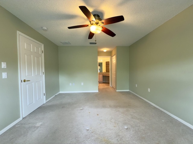 carpeted empty room with a ceiling fan, baseboards, a textured ceiling, and a smoke detector