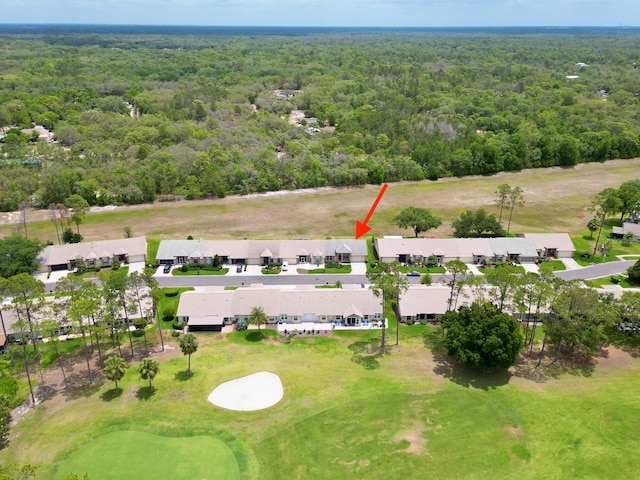 aerial perspective of suburban area featuring a heavily wooded area and a golf club