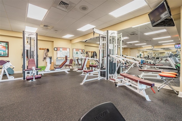 exercise room featuring a drop ceiling