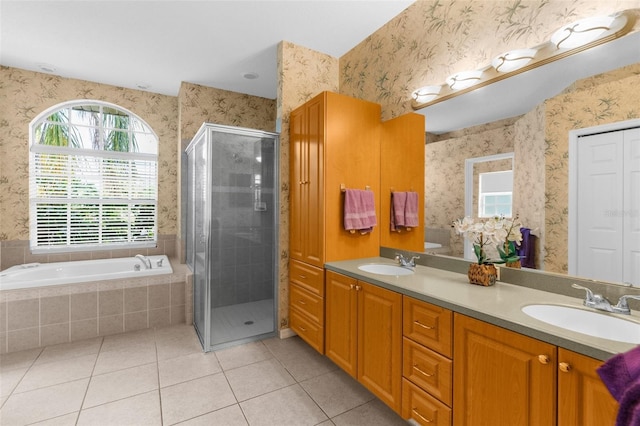 11443 Marsh Creek Ct, New Port Richey, FL 34654 - bathroom with wallpapered walls, tile patterned floors, a stall shower, double vanity, and a bath