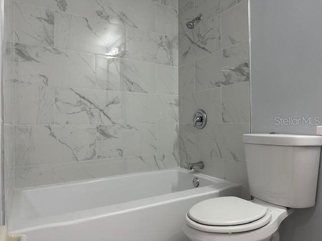 bathroom with toilet and shower / bathtub combination