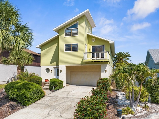 6321 Garland Ct, New Port Richey, FL 34652 - view of front of property with a balcony, a garage, stucco siding, and driveway