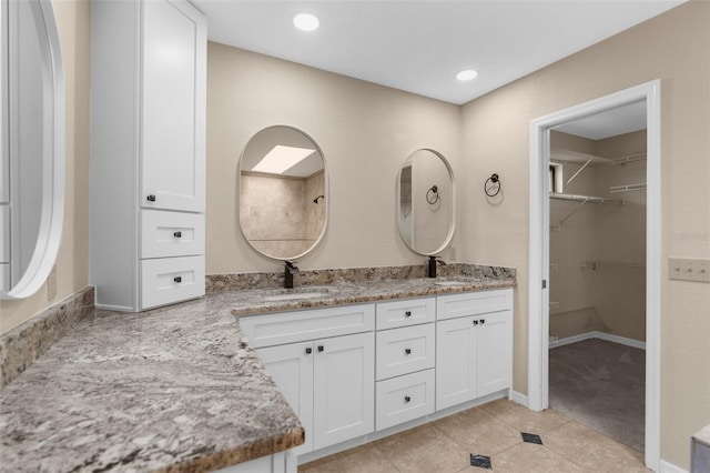 6321 Garland Ct, New Port Richey, FL 34652 - full bathroom with double vanity, tile patterned floors, a walk in closet, and recessed lighting