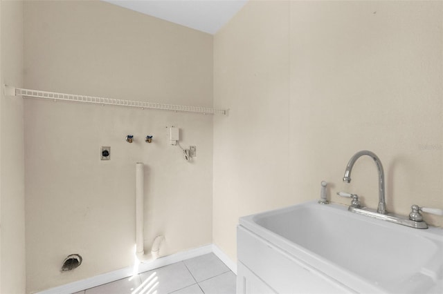 6321 Garland Ct, New Port Richey, FL 34652 - laundry room with hookup for a washing machine, light tile patterned flooring, hookup for an electric dryer, and baseboards