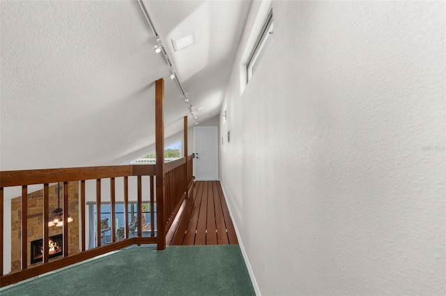 6321 Garland Ct, New Port Richey, FL 34652 - hall with rail lighting, baseboards, vaulted ceiling, and wood finished floors